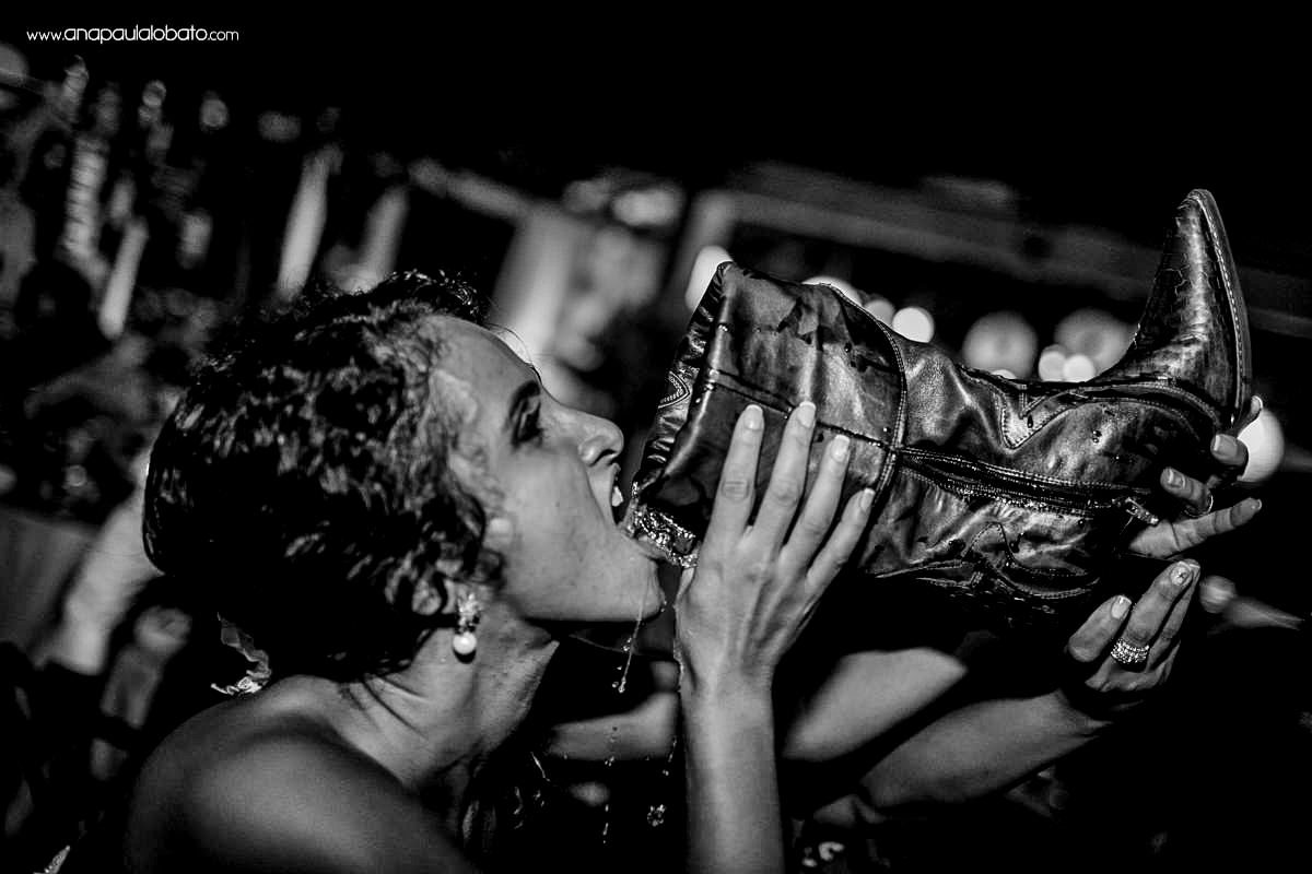 bride drinks beer in a boot