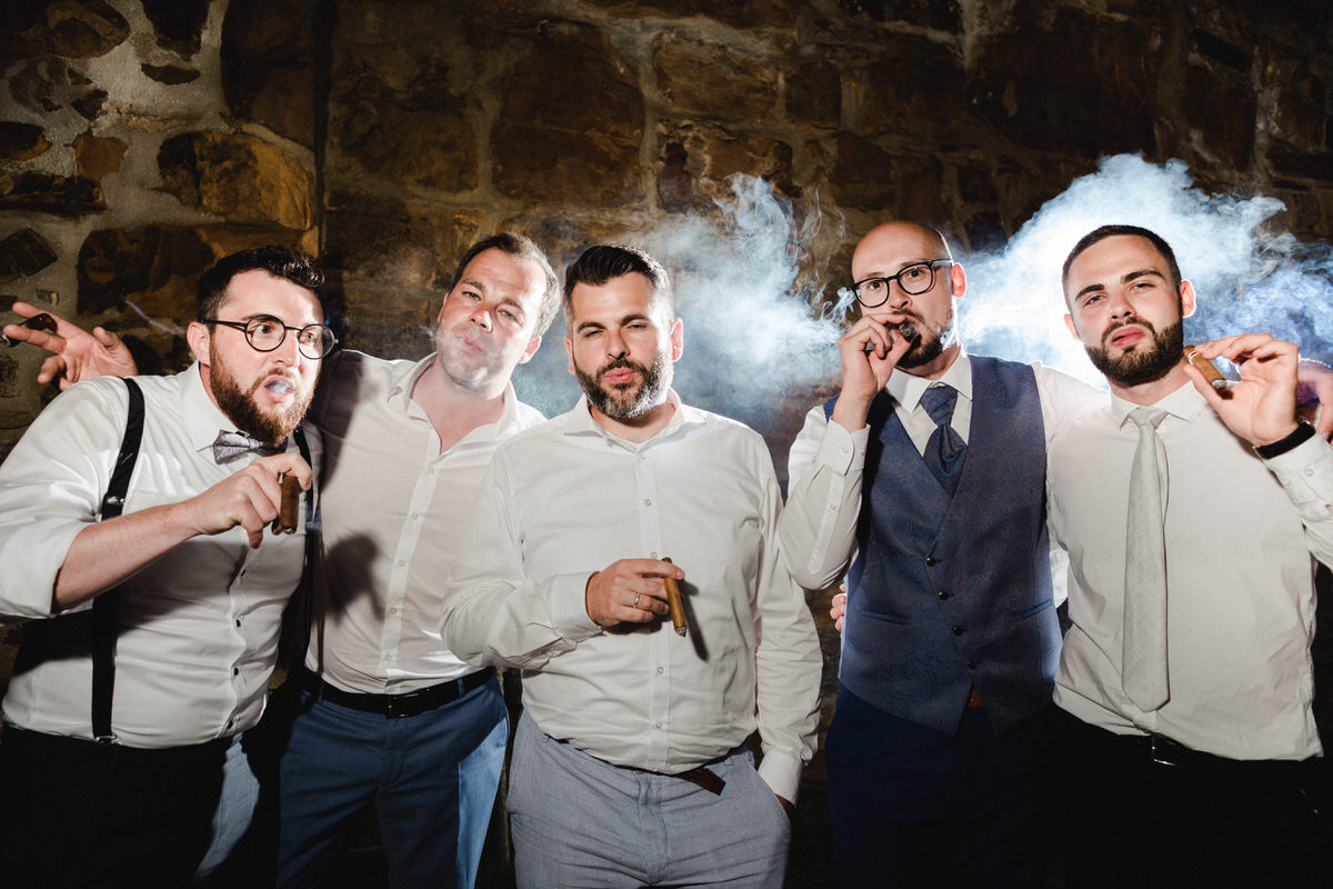groom smoking with his friends